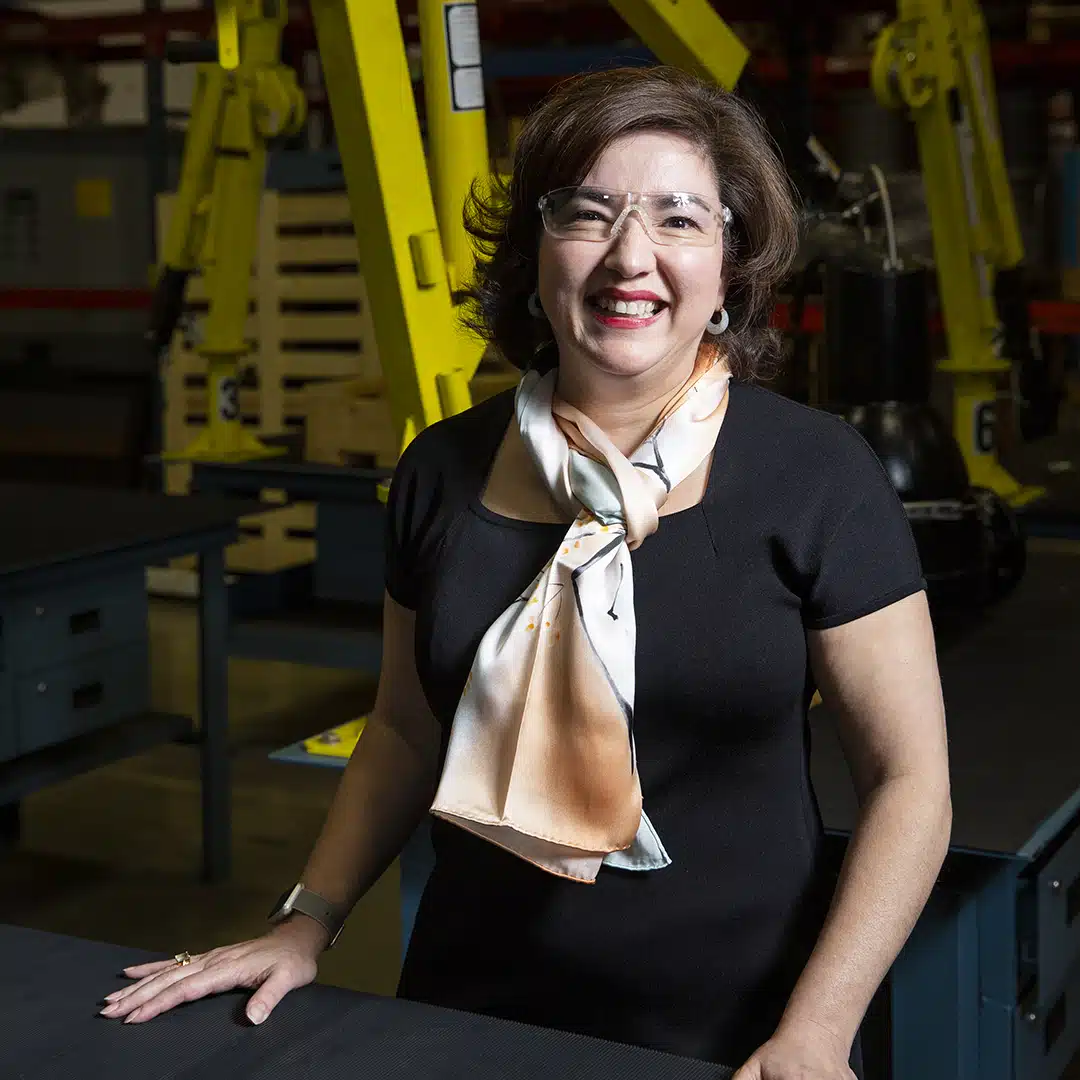 Rebecca O'Mara, Grundfos, seated in front of machinery, thumbnail image