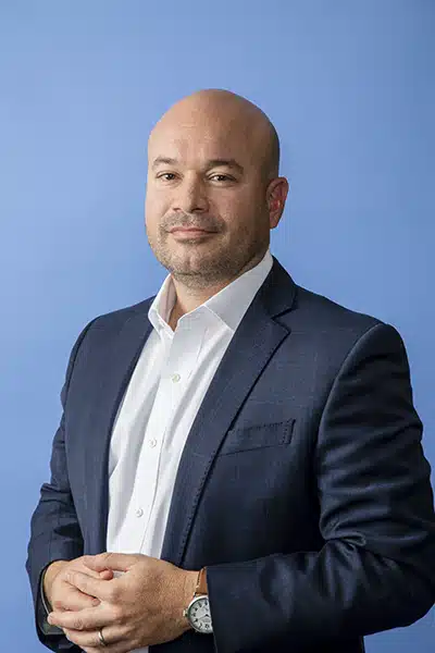 Ricardo Madan, TEKsystems, portrait blue background