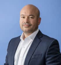 Ricardo Madan, TEKsystems, portrait blue background