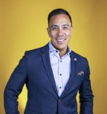 Guillermo Diaz, SVP of Customer Transformation, Cisco Systems, portrait yellow background