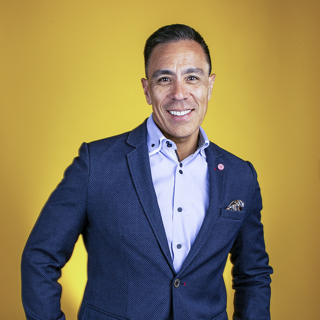 Guillermo Diaz, SVP of Customer Transformation, Cisco Systems, portrait yellow background