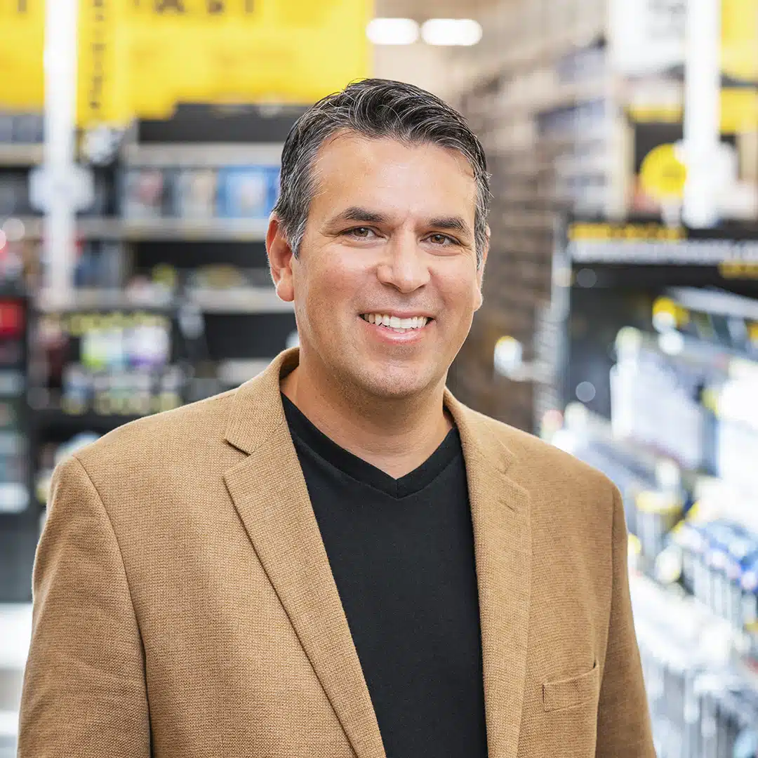 Adolfo Rodriguez, SVP of IT Transformation, Advance Auto Parts_portrait brown jacket thumbnail