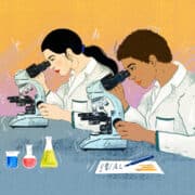Two women scientists of color look into their respective microscopes to study material. They are both wearing lab coats and surrounded by various solutions and a document with their notes on it.
