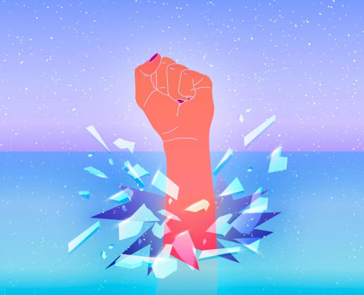 A woman's fist breaks through the glass ceiling, shattering it.