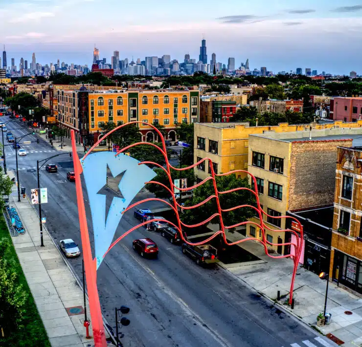 A metal re-envisioning of the Puerto Rican flag is pictured high above a Chicago street