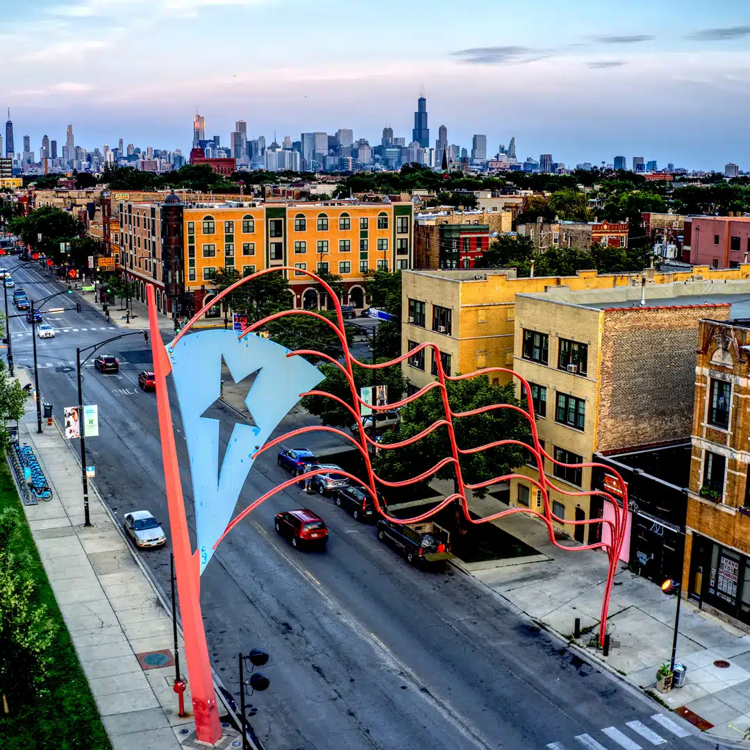 A metal re-envisioning of the Puerto Rican flag is pictured high above a Chicago street