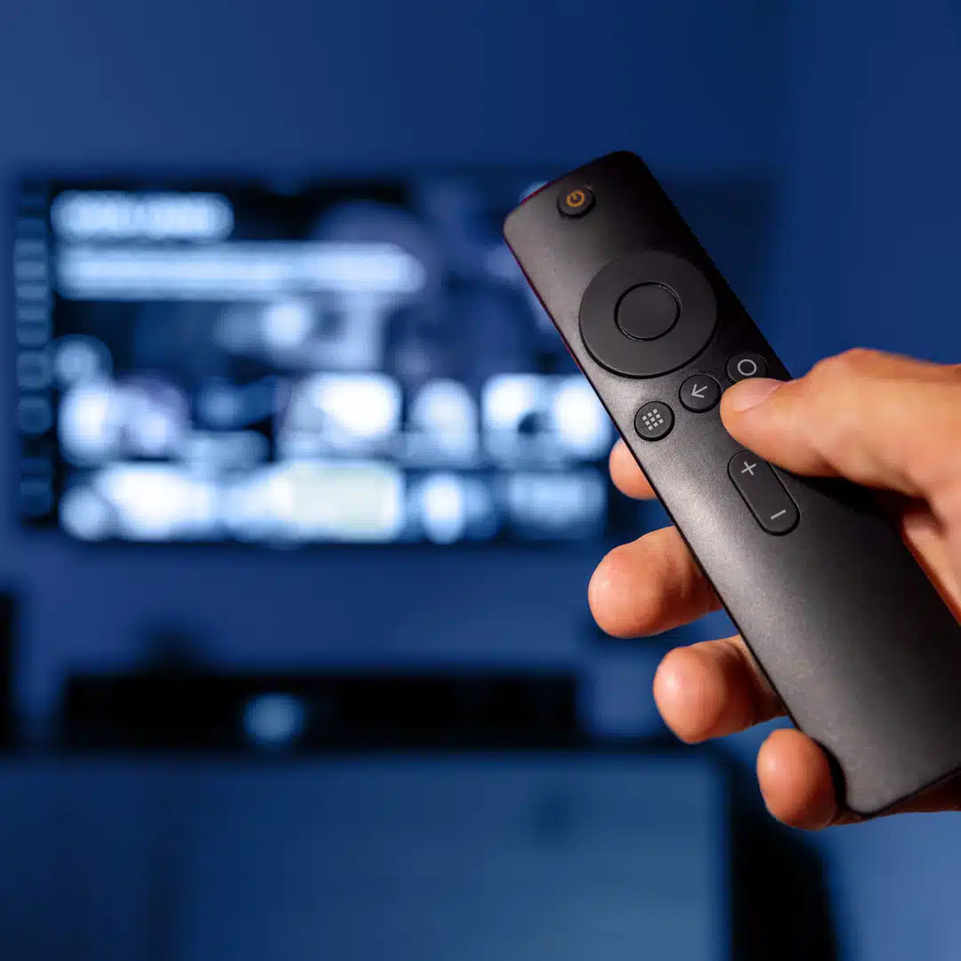 A person is holding a SmartTV remote while on Netflix