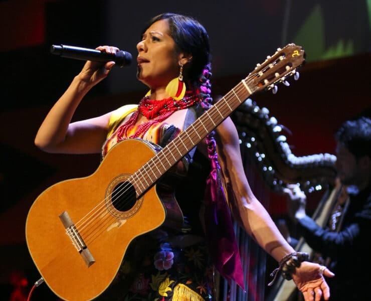 Mexican American singer-songwriter and activist Lila Downs sings with a guitar strapped to her chest