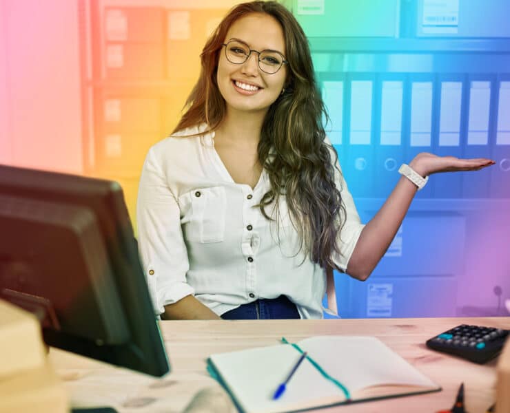 LGBTQ+ Lation-Owned Businesses image of woman sitting behind her desk with rainbow filter