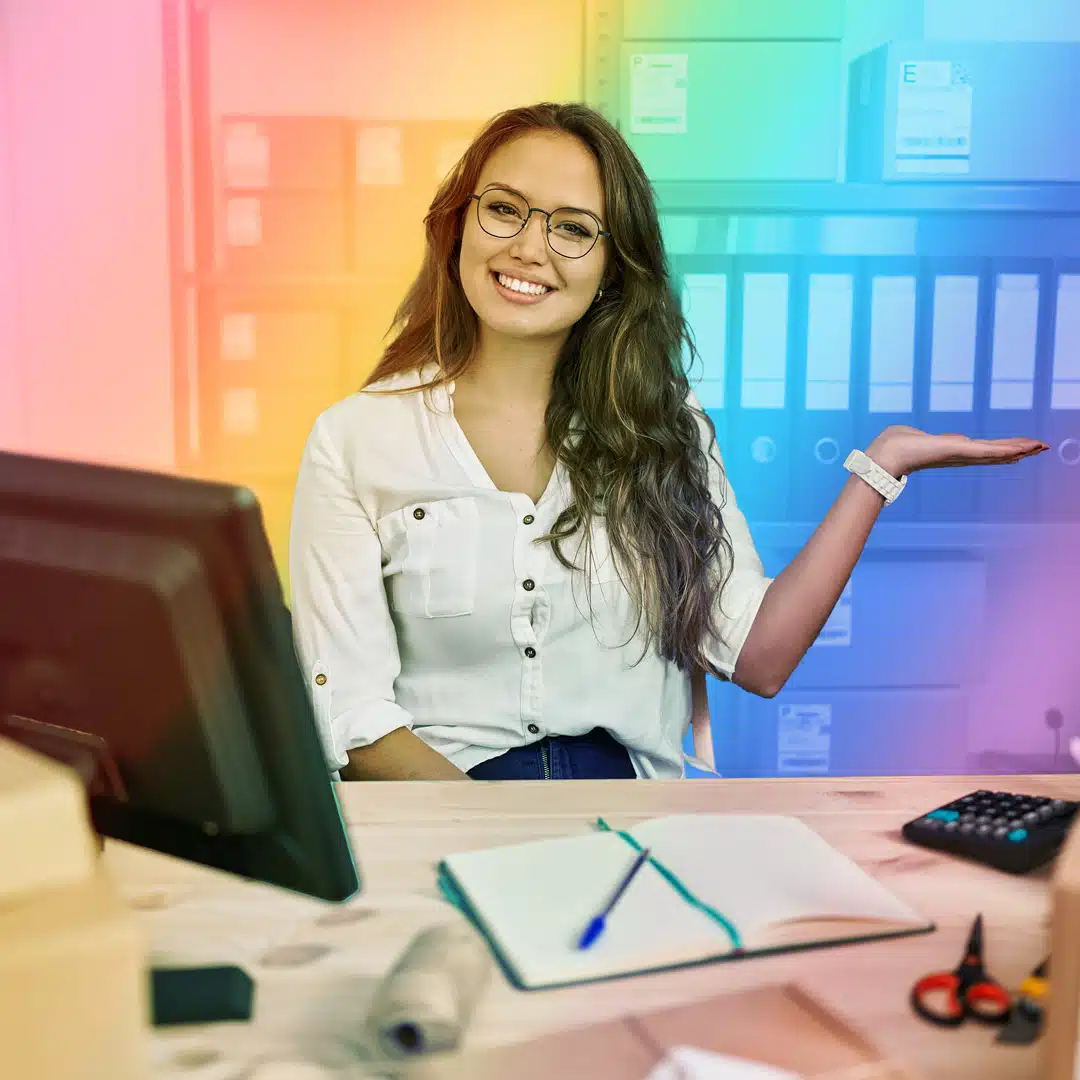 LGBTQ+ Lation-Owned Businesses image of woman sitting behind her desk with rainbow filter